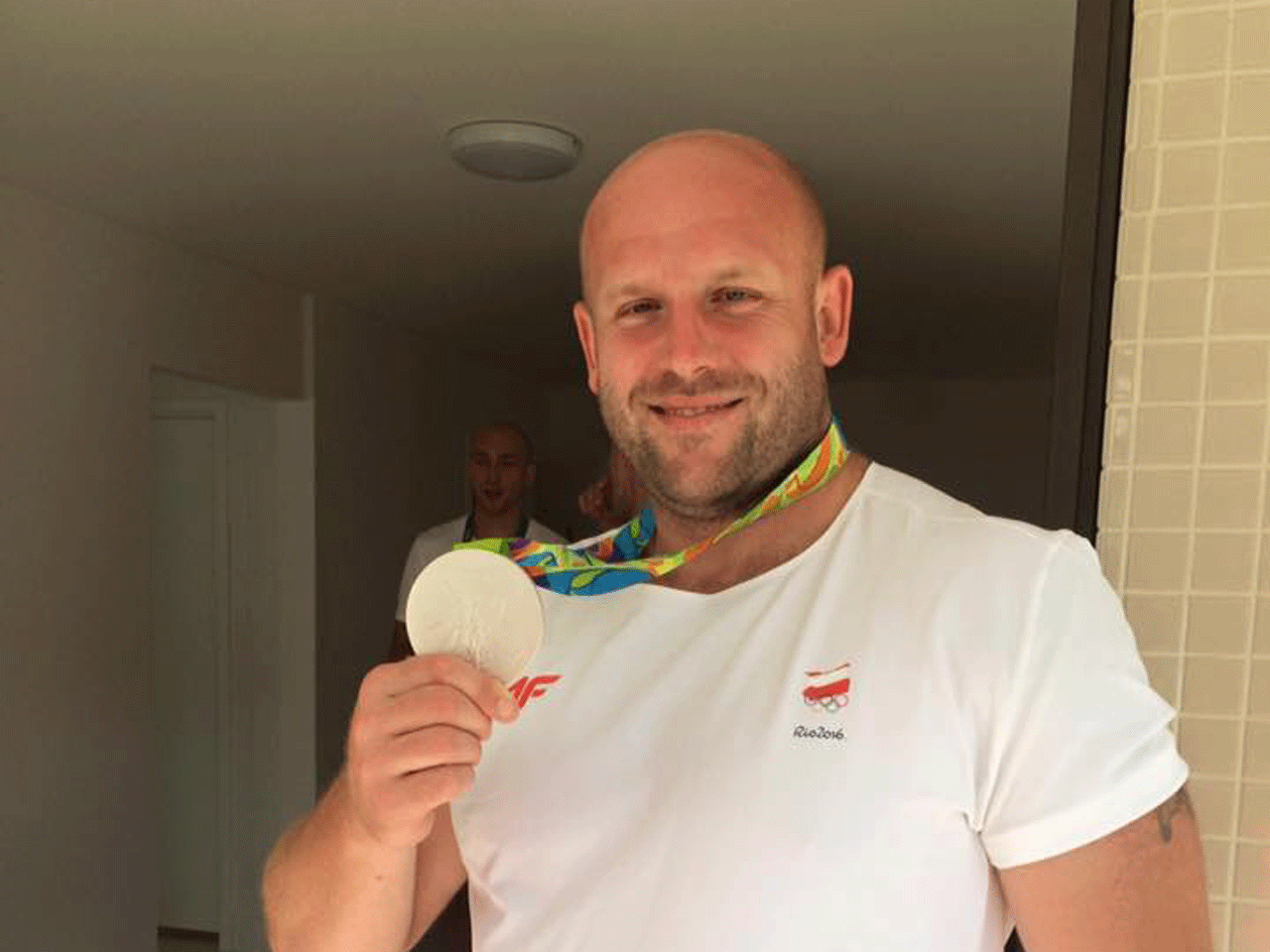 Polish Olympian Piotr Malachowski Auctions Silver Medal For Boy With