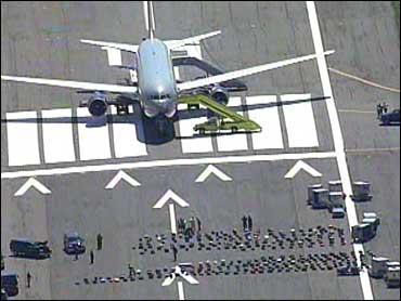 Passenger Disturbance Diverts Plane - CBS News