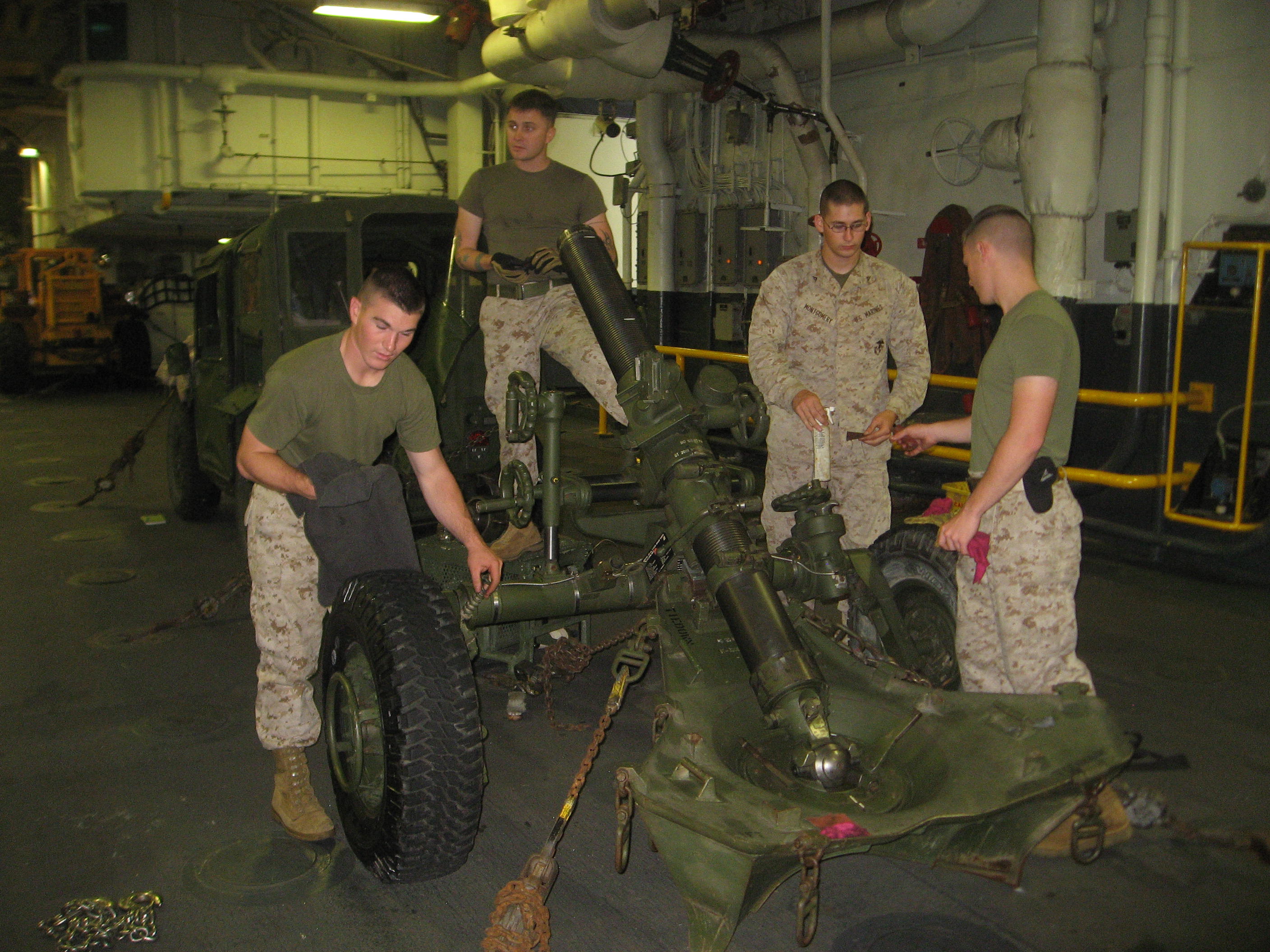 marine-working-on-the-120mm-gun-in-welldeck-of-uss-wasp.jpg 