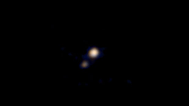 Spacecraft takes first color image of Pluto - CBS News