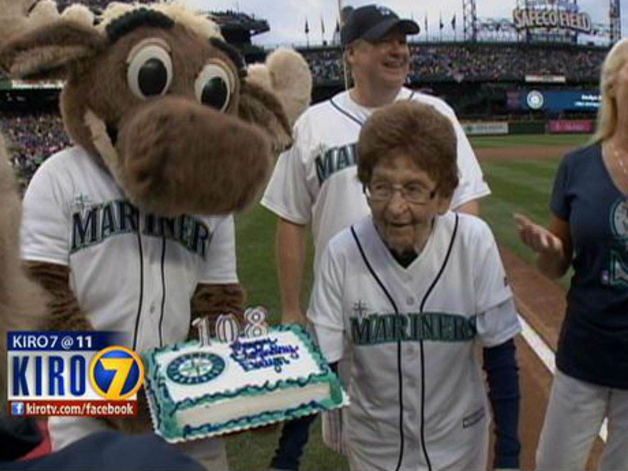 Seattle Mariners pitcher and Moose mascot stand up against