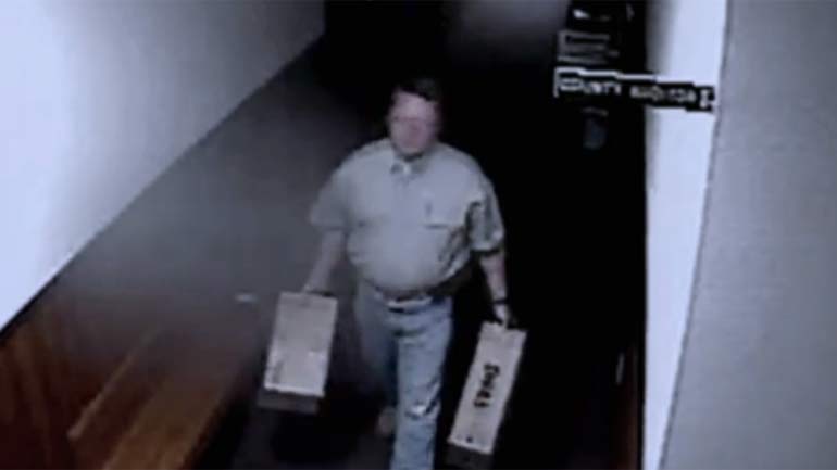 Eric Williams shown on surveillance video with computer equipment 