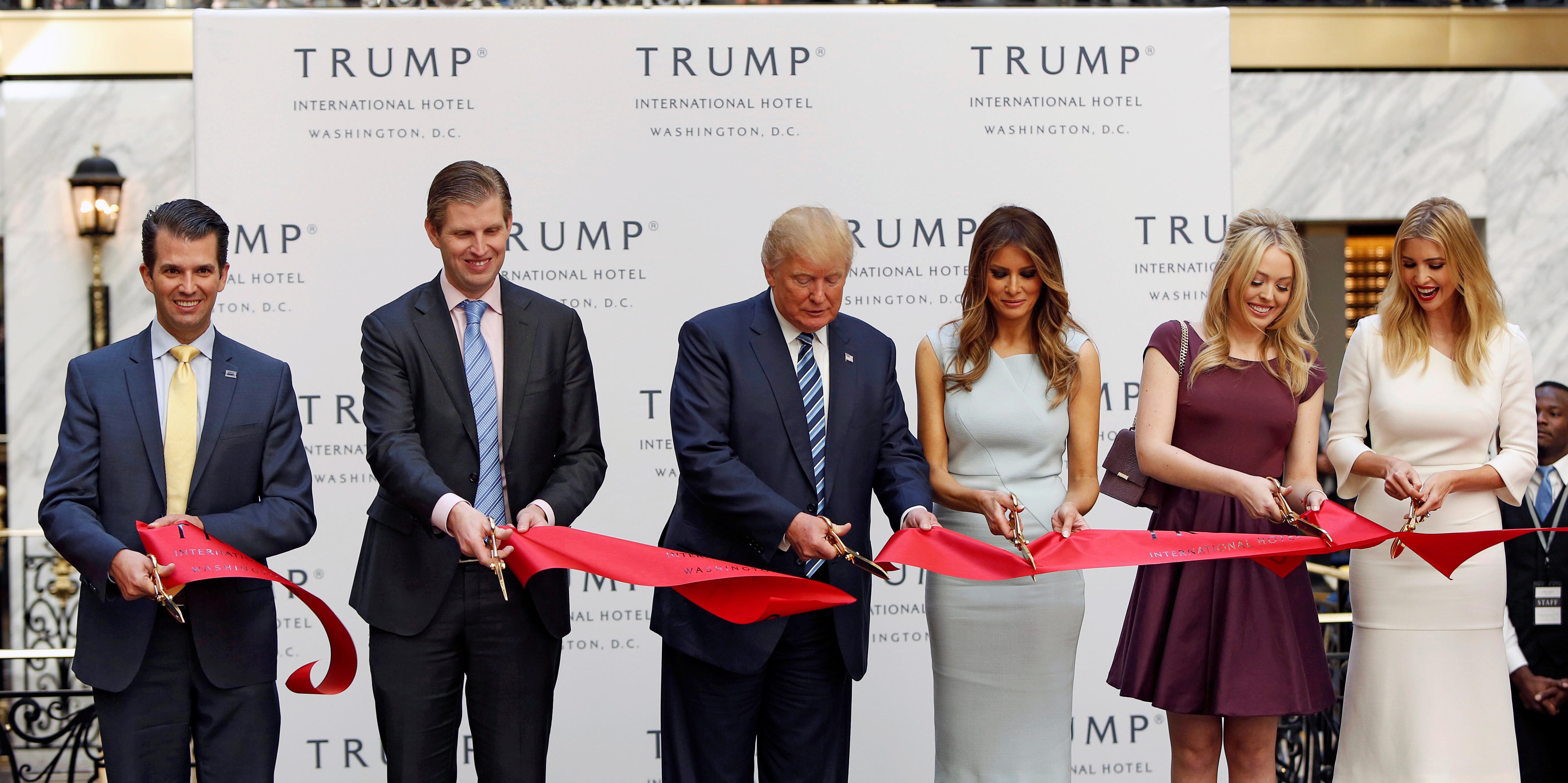 U.S President Donald Trump, center, joins a ribbon cutting