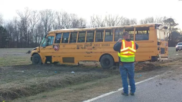 Driver charged after school bus carrying 19 overturns - CBS News