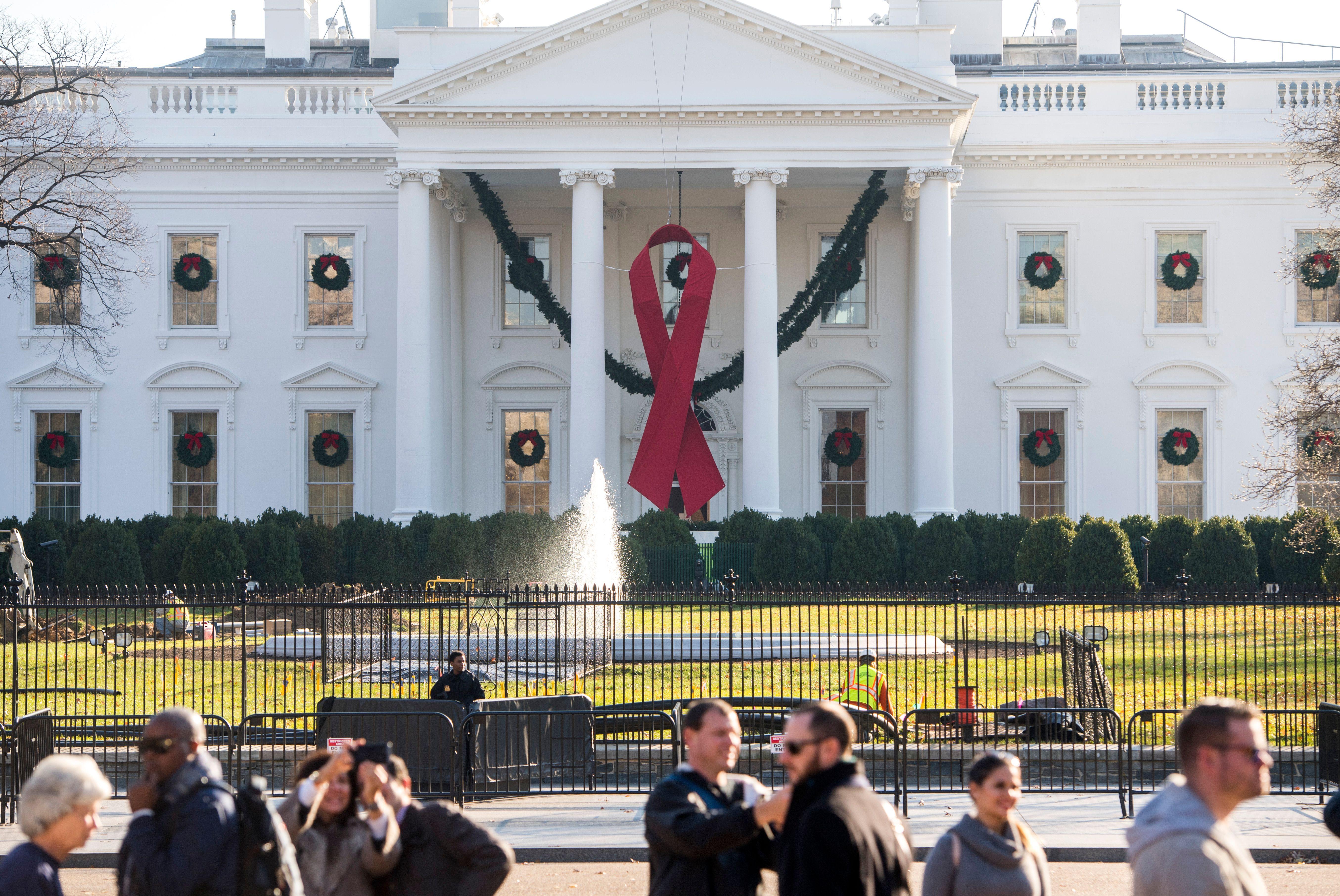White House hangs red ribbon for World AIDS Day - CBS News