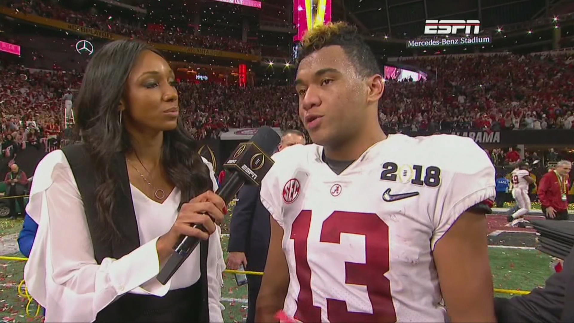 Tua Tagovailoa Alabama Crimson Tide Unsigned White Jersey Holding Up National Championship Trophy Photograph