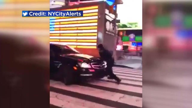 Driver who hit NYPD officer in Times Square remains at large - CBS News