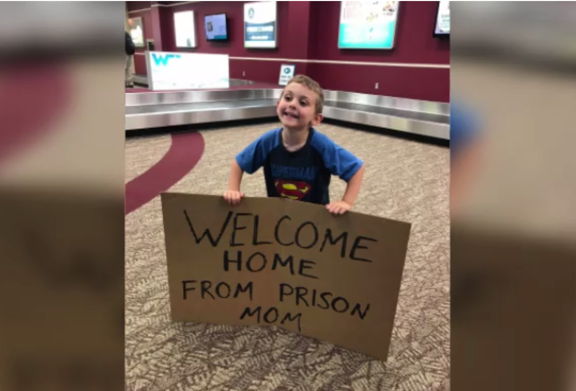 home from prison mom" Boy's joke sign for mom returning from trip goes viral CBS News