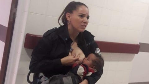 Photo of police officer Celeste Ayala breastfeeding malnourished baby