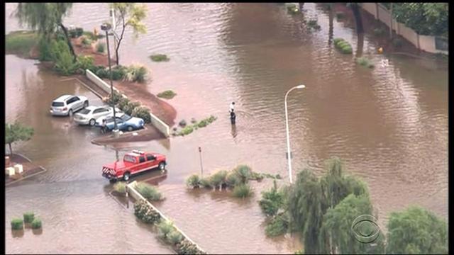 Record rainfall leads to deadly flooding in Arizona - CBS News