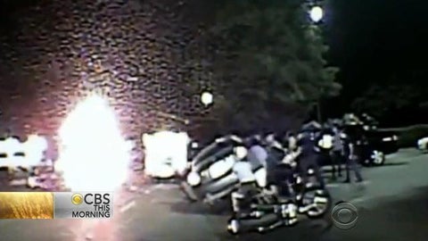 Bystanders and first responders lift car to free trapped woman - CBS News
