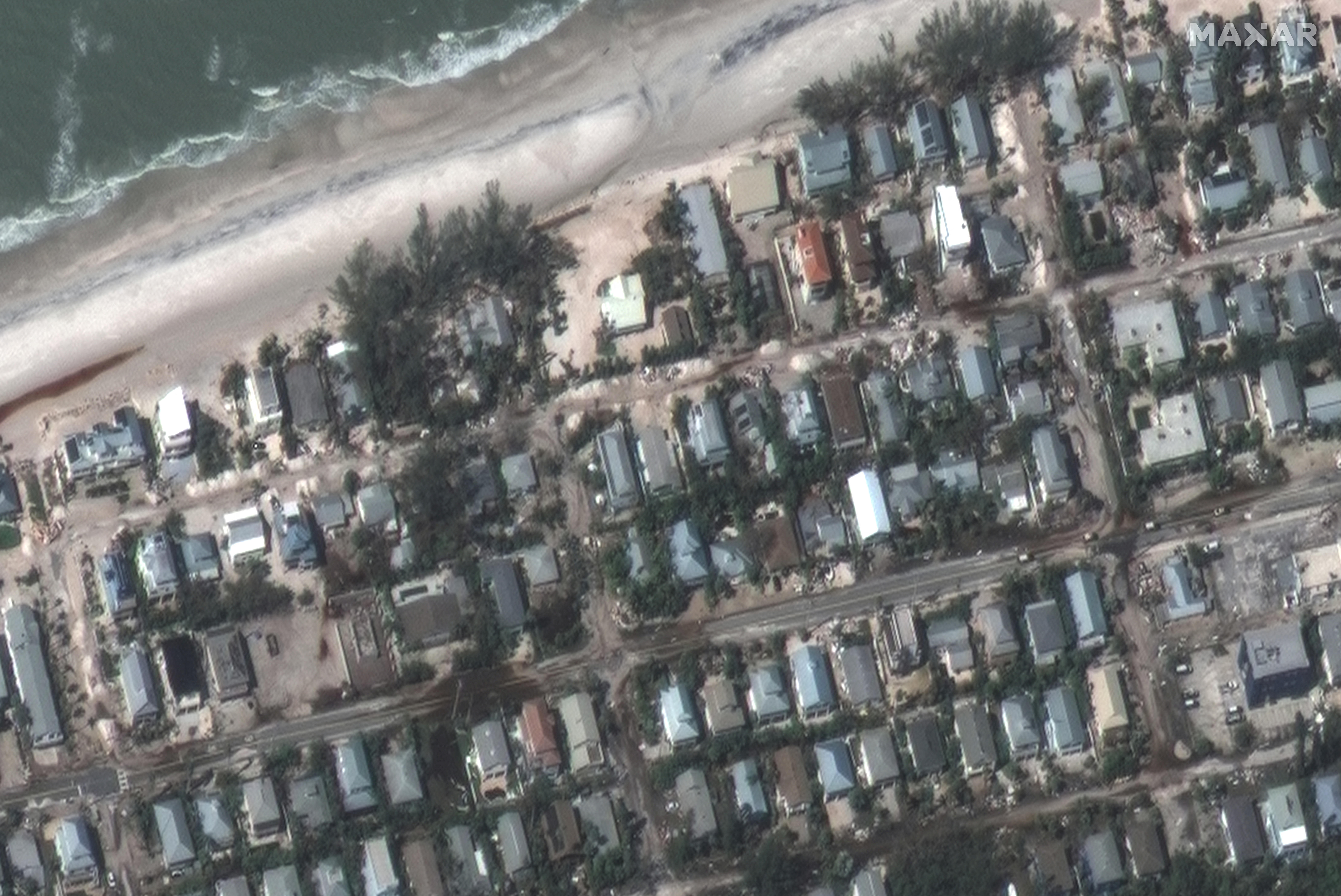 A satellite image shows sand and water on the streets after Hurricane Milton in Holmes Beach, Anna Maria Island 