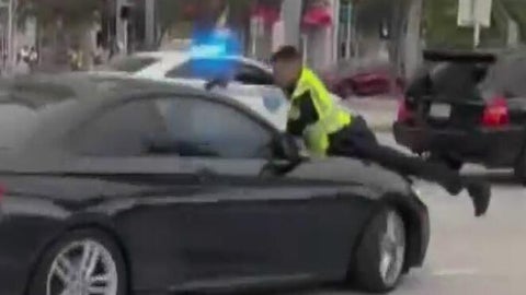 Cellphone video captures Miami officer firing at driver on hood of ...