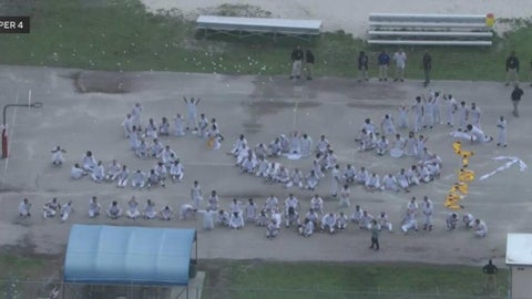 Detainees seen signaling "SOS" at Krome Detention Center, as