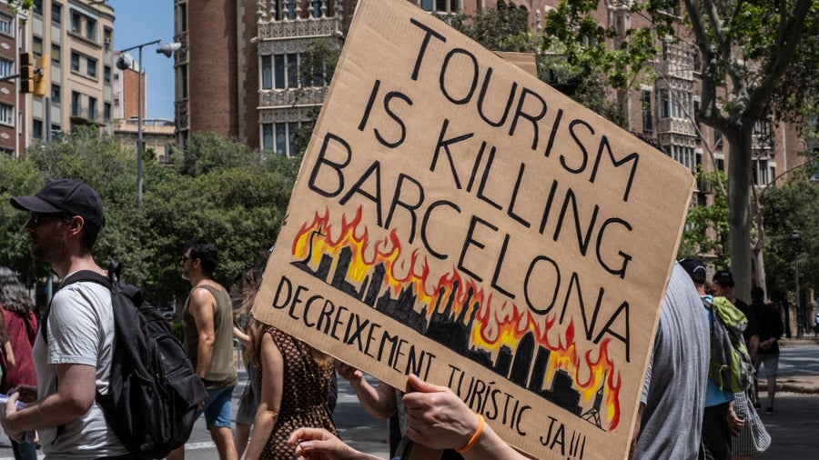 Protesters in Spain shoot water guns at tourists in demonstration ...