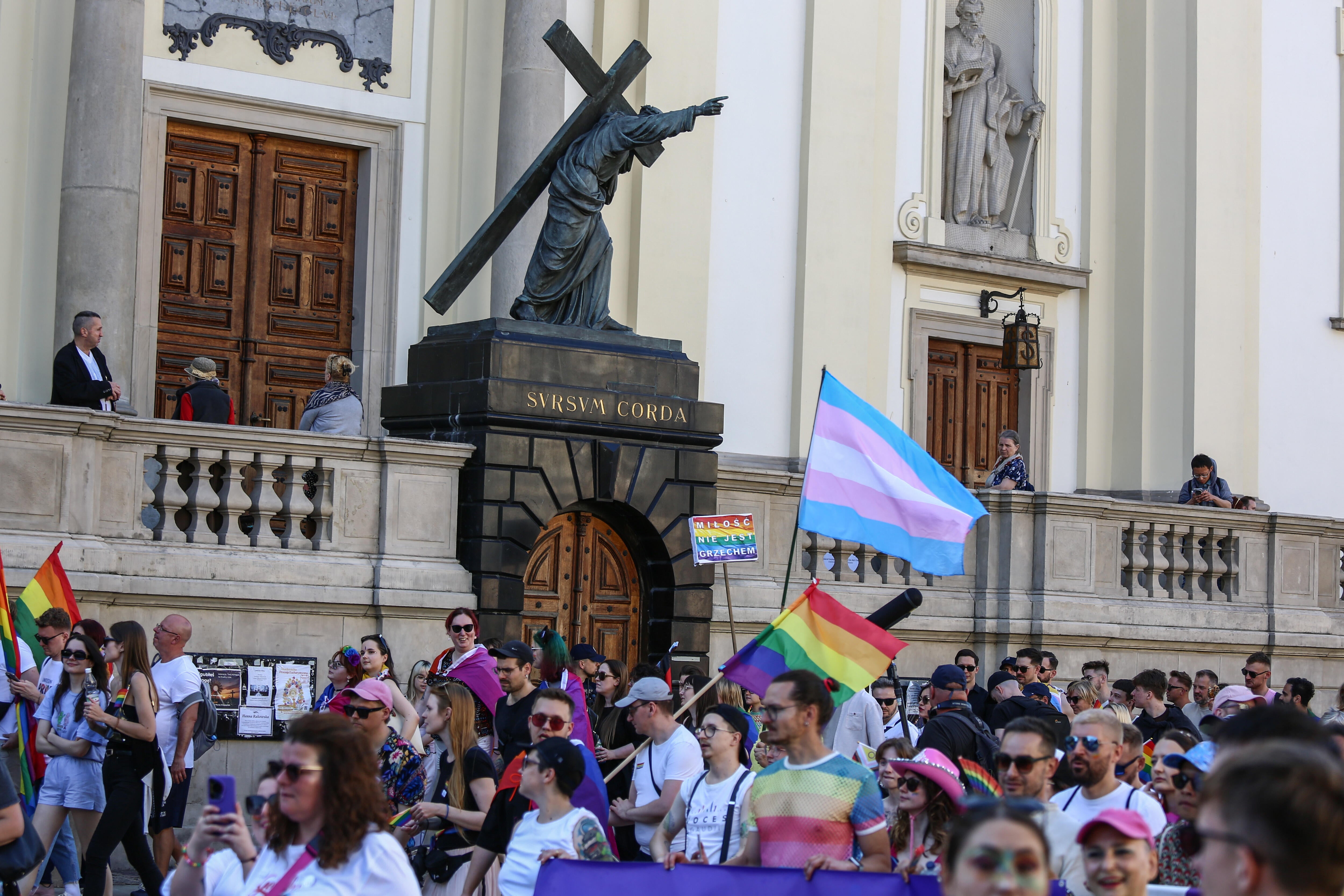 Participants with rainbow, bisexual, and transgender flags 