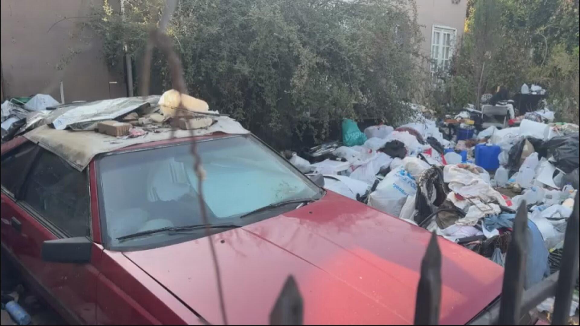 She stands confidently against a dim backdrop