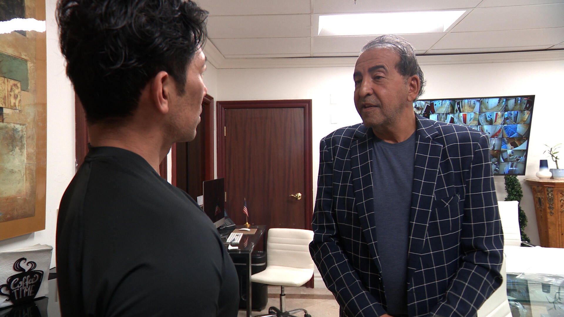 Kambiz Merabi talks to Adam Yamaguchi in the conference room of the Friar St. building.