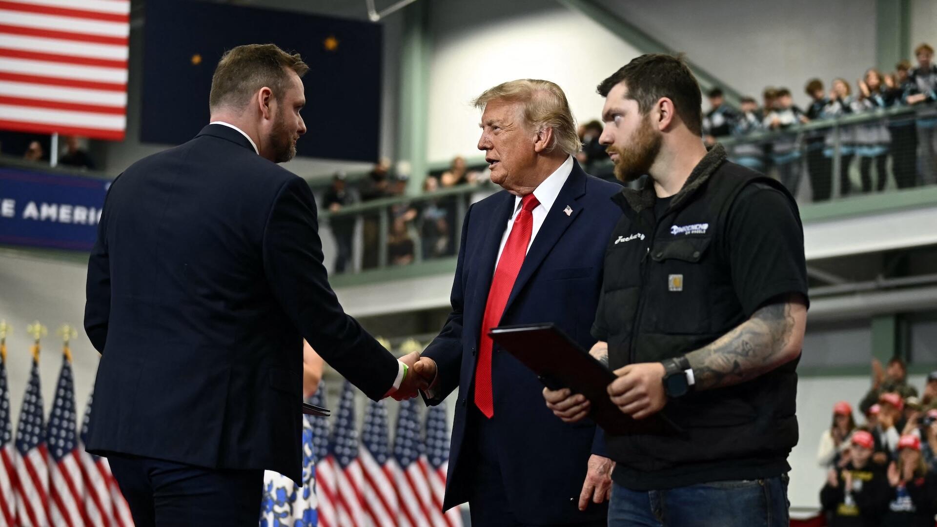 Trump pardons 2 auto workers on stage during rally in Alaska