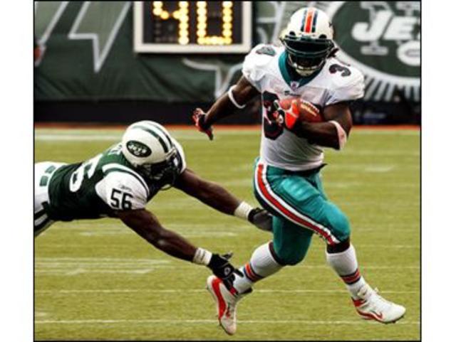 Miami Dolphins' Ricky Williams (34) scores on a 1-yard run in the fourth  quarter against the Buffalo Bills Sunday, Sept. 21, 2003, in Miami. Williams  carried a franchise-record 42 times for 153