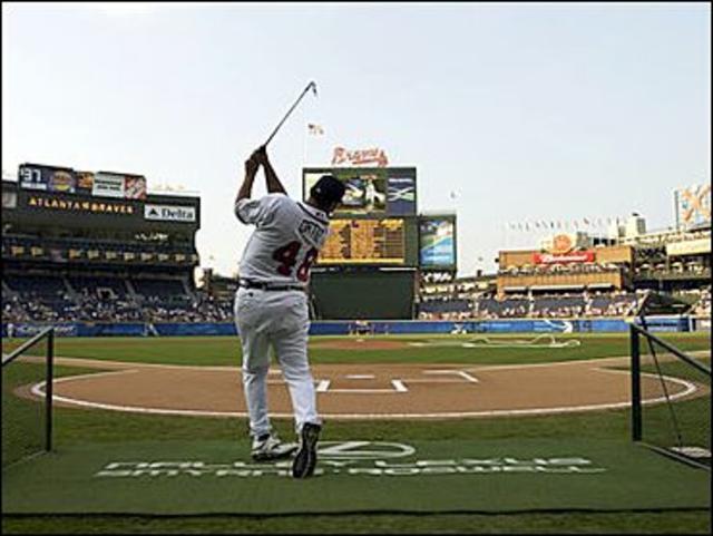 Montreal Expos' Tony Batista, left, celebrates with first base