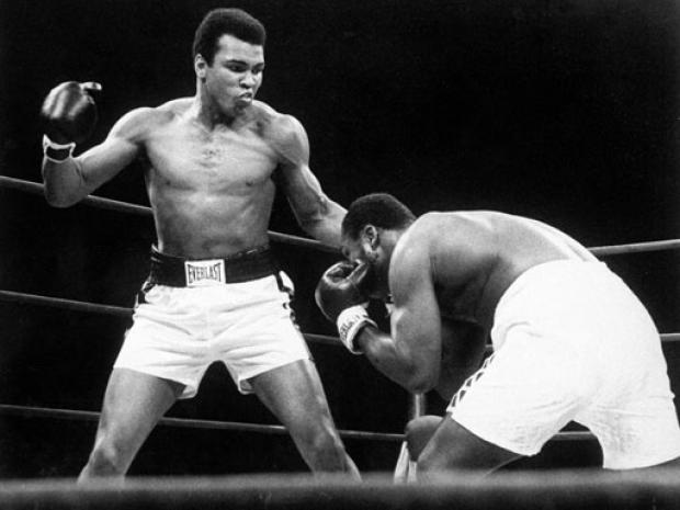 Muhammad Ali throws a punch at Joe Frazier 