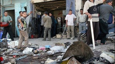 Iraqis began to clear the site of a bomb explosion 