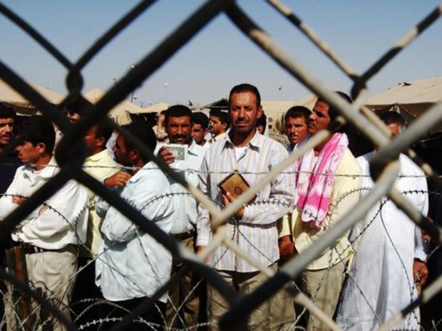 Iraqi detainees wait to be released at Abu Ghraib prison 