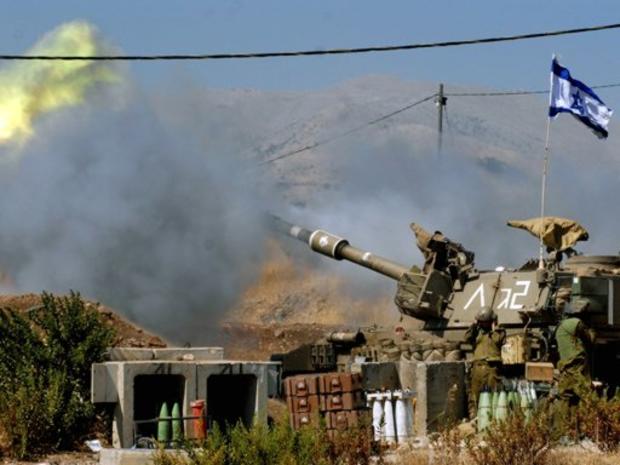 An Israeli mobile artillery piece fires towards southern Lebanon 