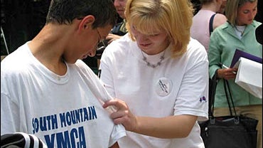 Operation Purple spokeswoman Jessica Lynch signs a camper's shirt. 