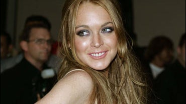 Actress Lindsay Lohan arrives at the opening of "Waist Down - Skirts By Miuccia Prada" 