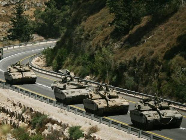 A convoy of Israeli tanks prepares to enter southern Lebanon near the northern Israeli village of Avivim, Wednesday, July 19, 2006. 