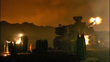 An Israeli mobile artillery unit fires towards southern Lebanon from the northern border of Israel 
