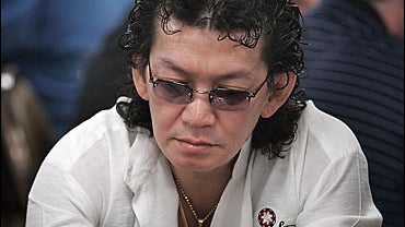 Scotty Nguyen throws away his cards while playing a hand at the World Series of Poker 