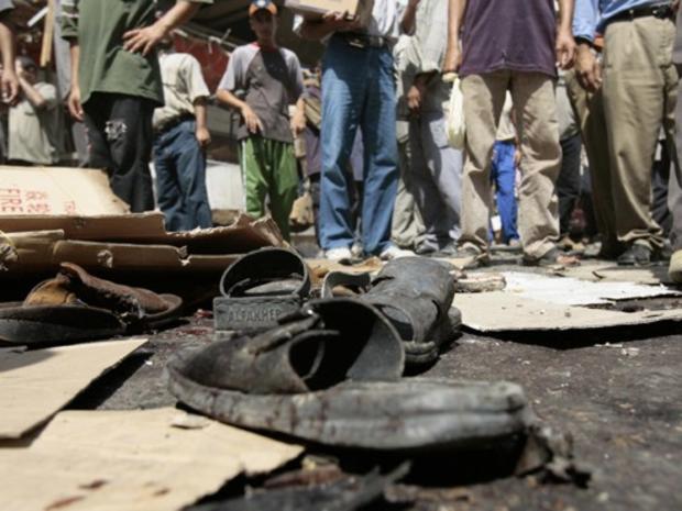 Sandals of Iraqi victims lay at the site where two roadside bombs exploded in Baghdad 