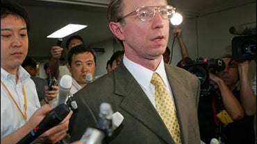 Acting Ambassador of Russia, Mikhail Galuzin, surrounded by reporters in Tokyo, Aug. 16, 2006, after a Russian border patrol fired on a Japanese fishing boat. 