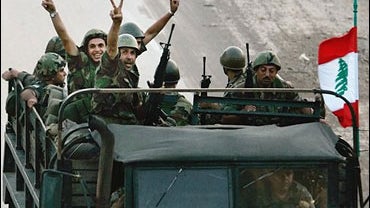 Lebanese army soldiers flash the victory sign as the head down the highway towards south Lebanon in Damour, Lebanon, Thursday Aug. 17, 2006. 