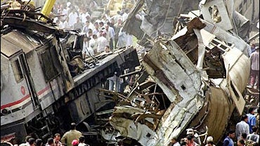 People gather at the site of a train crash in rail station of Qalyoub, north of Cairo, Egypt 
