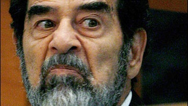 Former Iraqi leader Saddam Hussein looks across the court during day 3 of the Anfal Campaign trial 
