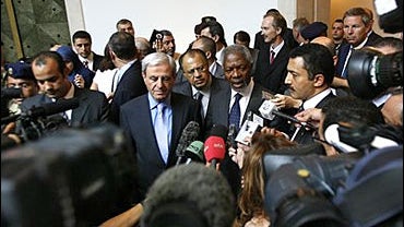 U.N. Secretary-General Kofi Annan, center right, flanked by Lebanon's Foreign Minister Fawzi Salloukh, center left, talks to the media upon his arrival at Beirut international airport, 