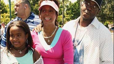 Whitney Houston, middle, Bobby Brown and their daughter 