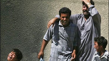 An Iraq family mourns as they arrive to take the body of their relative from the hospital mortuary in Baghdad, Iraq 