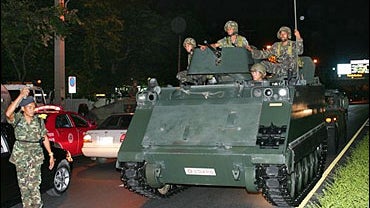 Thai soldiers ride tank next to Government house in Bangkok on Tuesday, Sept 19. 2006. 