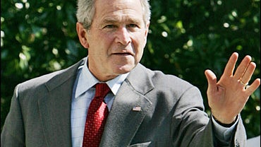 President Bush waves as he returns to the White House from Camp David, Md., 