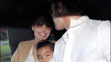 Angelina Jolie, left, her son Maddox, center, and Brad Pitt 