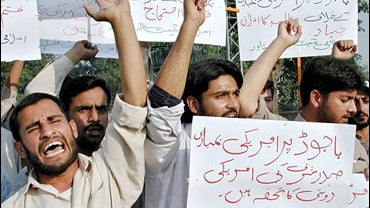 Pakistani students from a religious group chant slogans during a rally held in protest against the Pakistani military airstrike in Bajur 