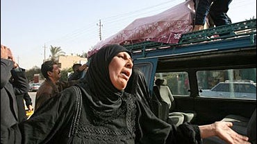 Iraqis react as they collect bodies of their relatives at the Yarmouk hospital in Baghdad 