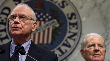 Iraq Study Group co-chairmen former secretary of state James Baker (R) and former chairman of the House International Relations Committee Lee Hamilton (L) conduct a news conference by the The Iraq Study Group on Capitol Hill 