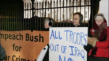 Anti-war protesters demonstrate in front of the White House, Wednesday, Jan. 10, 2007, as President Bush was making his address to the nation about his new policy dealing with the Iraq war. 