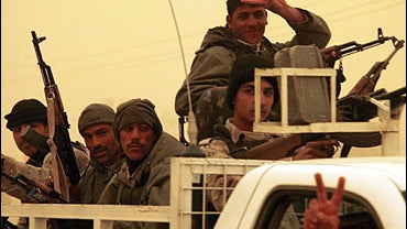 An Iraqi police commando flashes the victory sign as he returns January 29, 2007 with his comrades from a raging battle which pitted yesterday gunmen against Iraqi security forces 